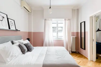 a bedroom with a large white bed and a window at Acropolis Heart 2BD Apartment in Plaka by UPSTREET in Athens