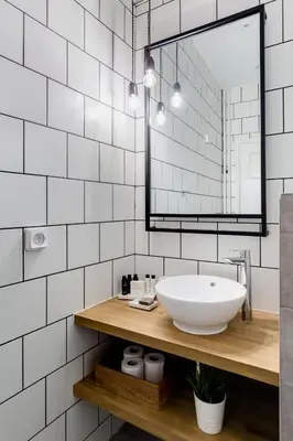 a bathroom with a sink and a mirror at Acropolis Heart 2BD Apartment in Plaka by UPSTREET in Athens