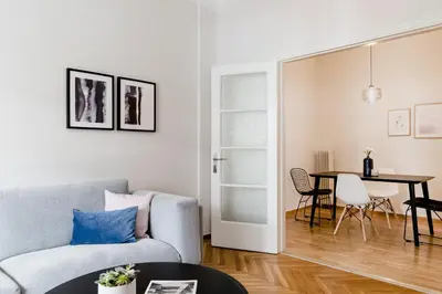 a living room with a couch and a table at Acropolis Heart 2BD Apartment in Plaka by UPSTREET in Athens