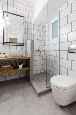 a bathroom with a tub and a sink and a toilet at Acropolis Heart 2BD Apartment in Plaka by UPSTREET in Athens