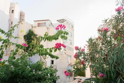 a building with pink flowers in front of it at Stylish, Basement Studio with Roof Garden Access - EP9B in Athens