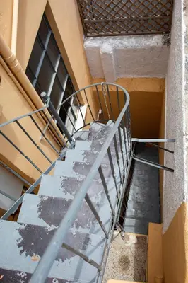 a staircase with a metal railing next to a building at Stylish, Basement Studio with Roof Garden Access - EP9B in Athens