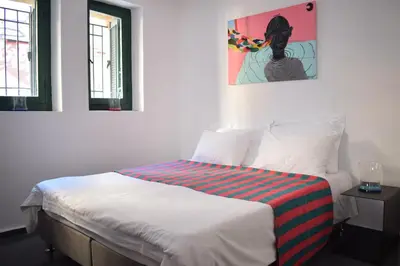 a bedroom with a bed with a painting on the wall at Stylish, Basement Studio with Roof Garden Access - EP9B in Athens