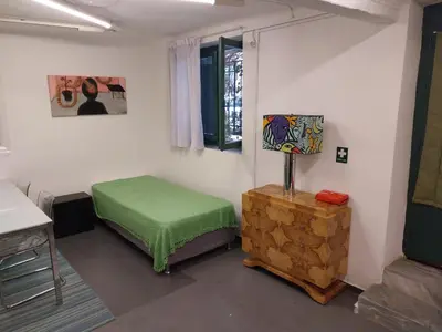 a room with a green ottoman in a room at Stylish, Basement Studio with Roof Garden Access - EP9B in Athens