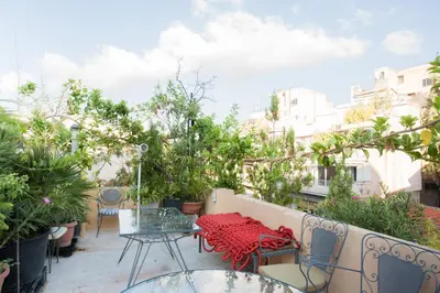 a patio with a table and chairs and trees at Stylish, Basement Studio with Roof Garden Access - EP9B in Athens