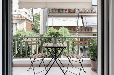 a table and two chairs on a balcony at Your 