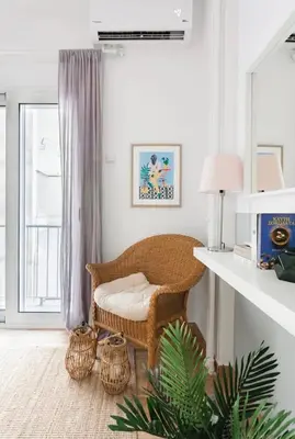 a living room with a wicker chair and a table at Your 
