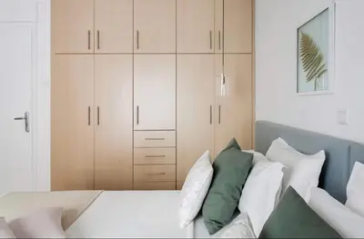 a bedroom with a bed with white and green pillows at Your 