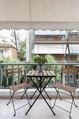 a table and two chairs on a balcony at Your 