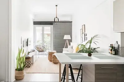 a kitchen with white walls and a table with plants at Your 