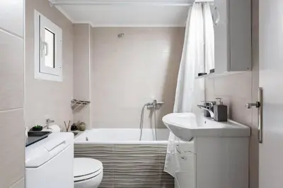 a white bathroom with a toilet and a sink at Your 