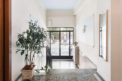 a hallway with a potted plant and a door at Your 