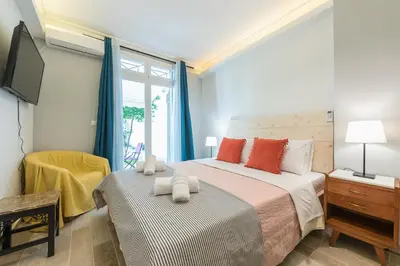 a bedroom with a large bed and a tv at Splash of Glam II 10 Steps from Acropolis in Athens