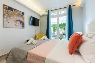a bedroom with a large bed with a window at Splash of Glam II 10 Steps from Acropolis in Athens
