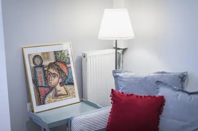 a living room with a couch and a table with a picture at Splash of Glam II 10 Steps from Acropolis in Athens