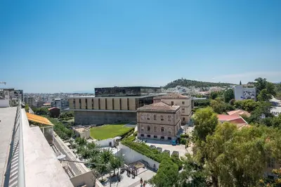 an aerial view of a city with a building at Splash of Glam II 10 Steps from Acropolis in Athens