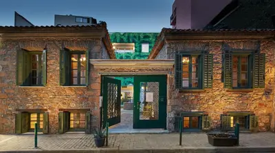 an old stone building with a green door at Athenian Residences in Athens