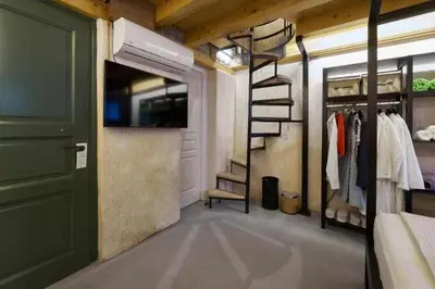 a room with a closet with a staircase and a door at Athenian Residences in Athens