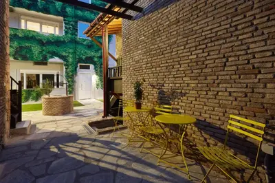 a patio with a table and chairs next to a brick wall at Athenian Residences in Athens