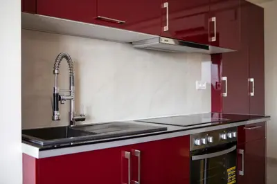 a kitchen with red cabinets and a sink at Unique 3-Bed, 3-Bath Apt with Acropolis Views SG69 in Athens