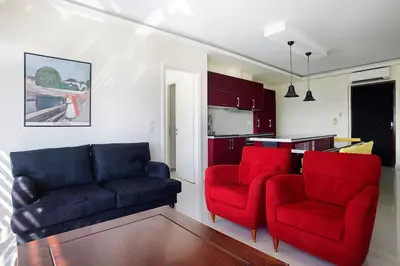 a living room with a couch and two red chairs at Unique 3-Bed, 3-Bath Apt with Acropolis Views SG69 in Athens