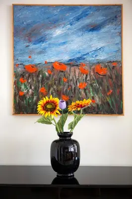 a vase with flowers in front of a painting at Unique 3-Bed, 3-Bath Apt with Acropolis Views SG69 in Athens