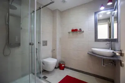 a bathroom with a toilet and a sink and a shower at Unique 3-Bed, 3-Bath Apt with Acropolis Views SG69 in Athens