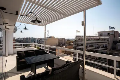 a balcony with a table and chairs on a building at Unique 3-Bed, 3-Bath Apt with Acropolis Views SG69 in Athens
