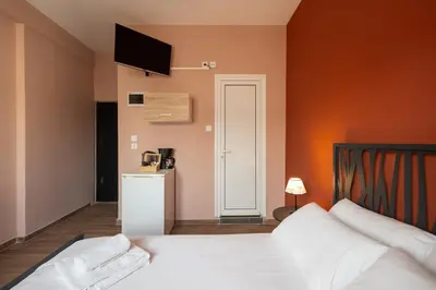 a bedroom with a bed and a tv on the wall at The Historical Center Studios in Athens