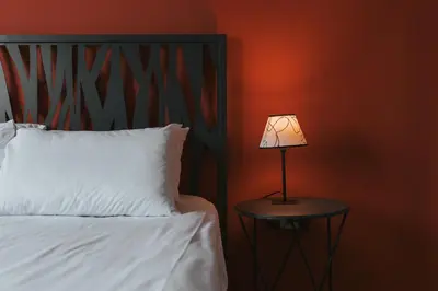 a lamp on a table next to a bed at The Historical Center Studios in Athens