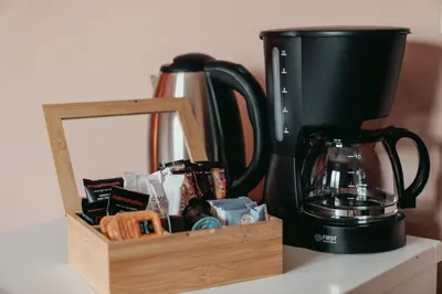 a coffee maker sitting on a counter next to a wooden box at The Historical Center Studios in Athens