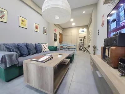 a living room with a couch and a table at “ZEUS”, STYLISH LUXURY BUSINESS SUITE in the heart of Athens. in Athens