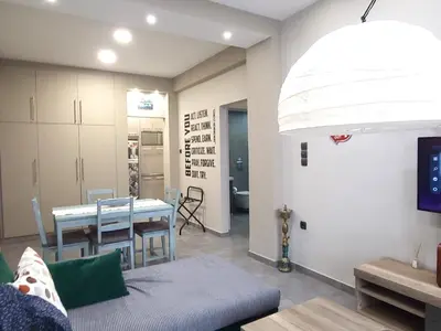 a living room with a table and a dining room at “ZEUS”, STYLISH LUXURY BUSINESS SUITE in the heart of Athens. in Athens