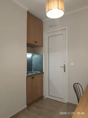 a kitchen with a white door and a counter at Lilly Apartments in Athens