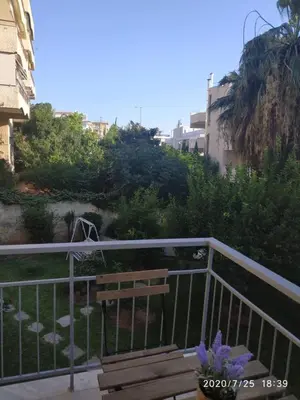 a wooden bench sitting on top of a balcony at Lilly Apartments in Athens