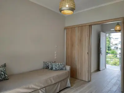 a living room with a couch and a sliding door at Lilly Apartments in Athens