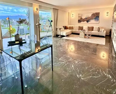 a living room with a glass table and a couch at One 360 Skyline Athens Penthouses in Athens
