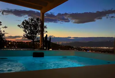 a swimming pool with a view of a city at One 360 Skyline Athens Penthouses in Athens