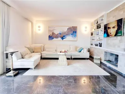 a living room with a white couch and a table at One 360 Skyline Athens Penthouses in Athens