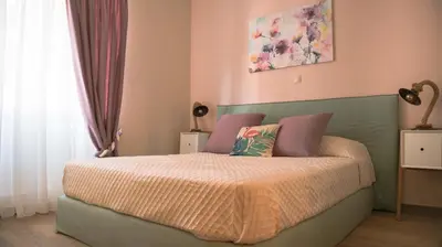 a bedroom with a bed with a green headboard at Traditional Thiseio Home in Athens