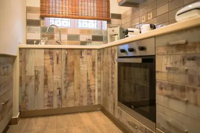 a kitchen with a sink and a stove at Traditional Thiseio Home in Athens