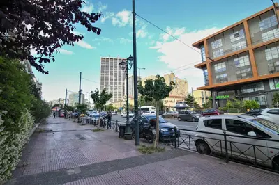 a busy city street with parked cars and buildings at Best neighbourhood apartment in Athens near metro station & hospitals in Athens
