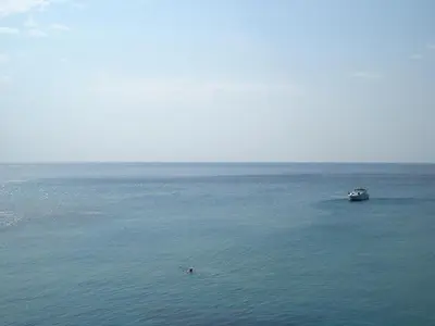 a boat in the middle of a large body of water at Panorama Hotel in Agia Marina Aegina