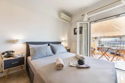 a bedroom with a bed with a view of a balcony at Photostory Art Studio in Athens