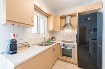 a small kitchen with a sink and a stove at Photostory Art Studio in Athens