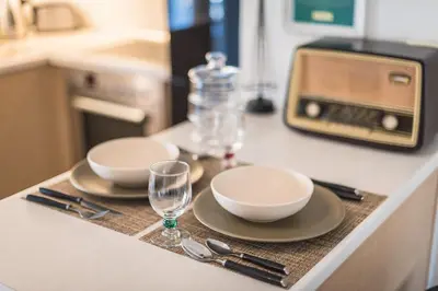 a table with plates and bowls and glasses on a counter at Photostory Art Studio in Athens