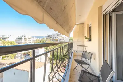 a balcony with chairs and a view of a city at Photostory Art Studio in Athens