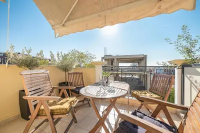 a patio with a table and chairs on a balcony at Photostory Art Studio in Athens