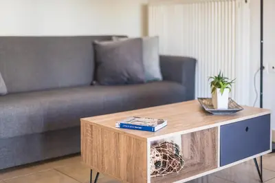 a living room with a couch and a coffee table at Photostory Art Studio in Athens