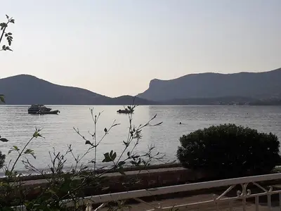 a view of a lake with a boat in the water at Kalos Gialos Sunrise Apartment in Porto Rafti